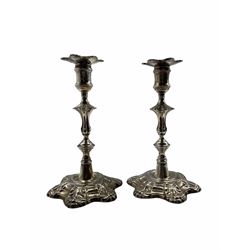 Pair of George II cast silver candlesticks with removeable unmarked shell moulded sconces, shell cushion knop stems with a baluster knop beneath and on lobed shell bases H22cm London 1752 Maker John Cafe 35oz