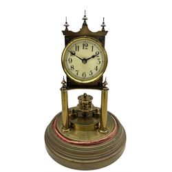 An early 20th century German torsion pendulum clock manufactured by Gustav Becker, with a 2-3/4” cream enamel dial within a spun bezel, upright Arabic numerals with minute track and steel spade hands, 400-day spring driven movement with a rotary pendulum and fast slow regulation, clear glass dome on a 7” circular brass effect base, movement stamped “Gustav Becker Freiberg in Schl, Medal Dor, serial No 2173752”.
