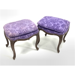  Pair of continental walnut upholstered dressing table stools, raised on scroll carved cabriole supports, W47cm  