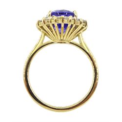 18ct gold oval tanzanite and round brilliant cut diamond cluster ring, hallmarked, tanzanite approx 4.50 carat, total diamond weight approx 1.00 carat