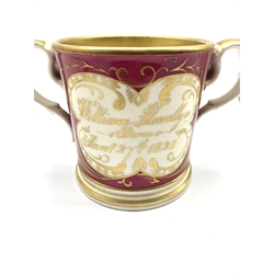 George IV Staffordshire pottery loving cup with gilt verse and  inscription Presented to William Llewellyn Born Jan 27th 1828, H12cm together with an early 19th century Bat Printed oval teapot stand decorated with a Mother and Child (2)