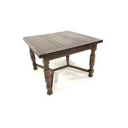 Early 20th century oak duo draw leaf dining table, top raised on turned supports united by castors, 107cm x 106cm, H75cm