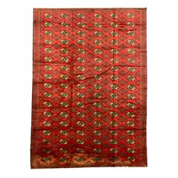 Large Afghan red ground carpet, decorated with repeating Gul motifs, in multiple band border with geometric design