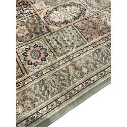 Indian design sage green ground rug, the field with various panels depicting Mirab motifs and foliate compositions with urn designs, the guarded border with repeating palmettes with stylised plant motifs