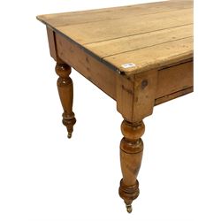 Victorian pine kitchen table, the three planked top over two drawers, raised on turned supports, terminating in brass castors W142cm, D80cm, H77cm