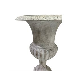 Pair of cast iron Campana shaped urns, egg and dart moulded rim over bulbous body with gadrooned underbelly, on tapered footed base and square plinth, white painted finish 