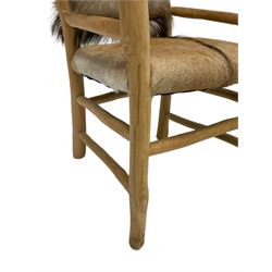 Rustic lightwood framed armchair with hide cover