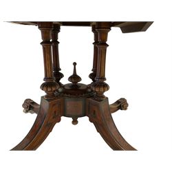 Victorian inlaid walnut loo table, oval quarter match figured veneer top with moulded edge, inlaid with satinwood and ebony scrolls and foliate decoration, the banded frieze with ebony stringing, the turned, fluted and gadroon cluster column support united by a quadriform base with splayed supports with ebony inlay terminating in geometric and foliate moulded feet with ceramic castors
