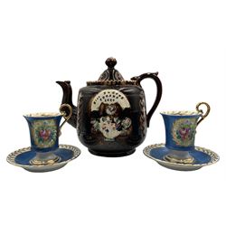 Victorian barge ware teapot  with a raised pattern of leaves and a basket of flowers inscribed 'Miss B Cook, Thorne 1880' H20cm and a pair of Limoges cabinet cups and saucers painted with a panel of flowers on a blue and gilt ground (3)