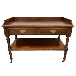 Late 19th century walnut washstand or buffet, the raised back on rectangular top with moulded edge, fitted with two drawers over under-tier, raised on ring turned supports terminating in ceramic castors