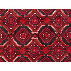 Persian red and indigo ground rug, overall geometric design, decorated with repeating stylised lozenge motifs, multiple band border each with repeating pattern, the central band with alternating stylised flower head and leaf motifs