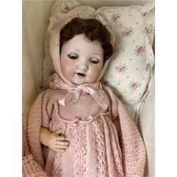 Armand Marseille bisque head doll no. 985, jointed composition body, sleeping eyes and brown hair, together with an early 20th century Dolls cream painted metal cot with cotton canopy 