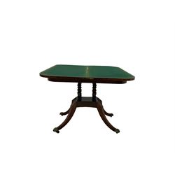 Regency mahogany crossbanded foldover table, with ebony strung frieze, on turned supports, quadripartite base and four sabre legs with brass paw feet and castors
