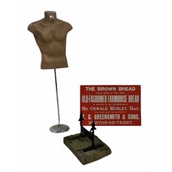 Cast metal boot scraper on a York stone base (W40cm) together with an injection moulded male torso mannequin on a chrome base (H135cm) and a reproduction advertising panel (W75cm)