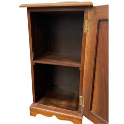 Edwardian walnut bedside cabinet, moulded top with arched back, enclosed by single door with figured panel, on bracket feet
