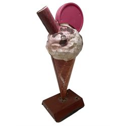 Large advertising shop display model of an ice cream, the waffle cone with vanilla scoop and chocolate sauce and flake, weighted base