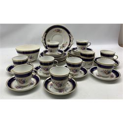 Late Victorian tea ware comprising eleven cups, twelve saucers, twelve cake plates, waste bowl, cake platter with bow detailing, decorated with sprays of pink and blue flowers with cobalt blue banding and gilding (37)