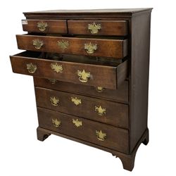 George III oak chest, rectangular top with moulded edge, fitted with two short over five long graduating drawers with brass handle plates and escutcheons, lower moulded edge on bracket feet