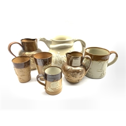 Collection of Doulton Lambeth relief moulded jugs, beakers and other stoneware together with a Victorian stoneware jug with serpent moulded handle, H19cm (7)