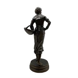 Ernest Charles Guilbert (French, 1815 -1865): Bronze standing figure of a girl holding a basket on circular base, H58cm