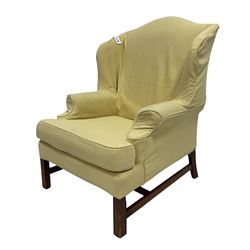 Georgian style wing back armchair, upholstered in lemon fabric, raised on square supports 