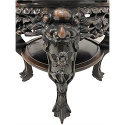 Late 19th to early 20th century carved hardwood jardinière or urn stand, shaped rose marble top enclosed by bead and scrolling foliate carved surround, the frieze rails carved and pierced with flowerheads, on dragon mask carved cabriole supports with ball and claw feet united by under-tier 