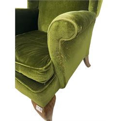 Parker Knoll - Pair of 20th century wingback armchairs, upholstered in green fabric, raised on oak cabriole supports 