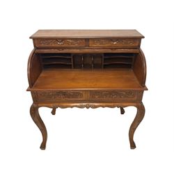 French design hardwood writing desk, the top fitted with two drawers with shell and foliate carved facias over the tambour roll top, enclosing fitted interior, the ornate base with two drawers over a shaped and carved apron, raised on cabriole supports with acanthus leaf decoration