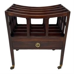 George III mahogany four-division Canterbury, the concave shaped dividers over a single drawer with pressed brass rosette plate and ring handle, raised on square supports terminating in brass cups and castors