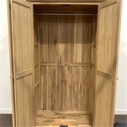 Contemporary solid oak double wardrobe, with panelled doors enclosing interior fitted for hanging, ( W110cm, H193cm, D58cm) together with a matching tall boy fitted with five short drawers, (57cm, H107cm, D42cm)