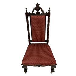Victorian mahogany nursing or hall chair, pierced and carved cresting rail with central cartouche flanked by finials, rope twist uprights, seat and back upholstered in crimson fabric, the frieze rail with central shell motif, raised on scrolled cabriole supports with ceramic castors