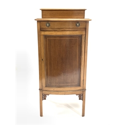 Edwardian walnut and boxwood strung bow front sheet music / side cabinet fitted with one drawer and cupboard enclosing three shelves, raised on square supports