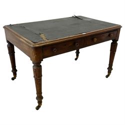 William IV mahogany library table, rectangular crossbanded top with inset writing surface, fitted with two cock-beaded frieze drawers with two faux drawers to the back, raised on lappet carved supports with brass castors