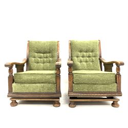 Pair of Early 20th century oak framed rocking chairs, upholstered in green fabric, raised on sprung base W65cm