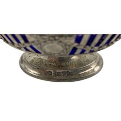 Continental silver cream jug with embossed decoration, import marks, Continental embossed silver strainer, Edwardian pierced silver salt with blue glass liner Chester 1906, pierced silver mustard with blue glass liner, pair of embossed silver pepperettes, one other and a glass salt with silver rim