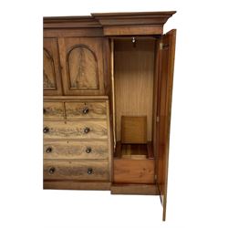 Victorian mahogany break front triple wardrobe, the projecting cornice over one central cupboard with two doors and two short and three long drawers, flanked by two cupboard doors opening to reveal interior fitted for hanging, raised on a plinth base