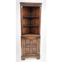 20th century distressed oak corner cupboard in the manner of Titchmarsh and Goodwin, the top section fitted with two shaped open shelves, four panelled cupboard door under enclosing one shelf, raised on bracket supports W64cm, H178cm