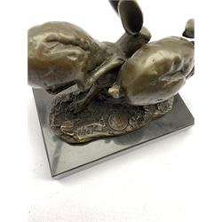 Bronze figure group, modelled as two hares in chase, signed 'Nick' and with foundry mark, upon a rectangular marble base, overall H11cm L13cm
