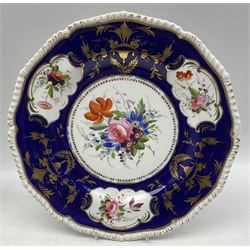 Pair of early 19th century Derby plates, hand painted with floral sprays on cobalt blue and gilt ground within shaped borders, D26cm, together with another Derby shaped plate, hand painted with floral sprigs (3)