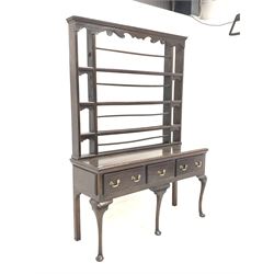 Georgian oak dresser, the four height plate rack with dentil cornice and scroll carved apron over base with three drawers raised on cabriole supports, W141cm, H200cm, D48cm