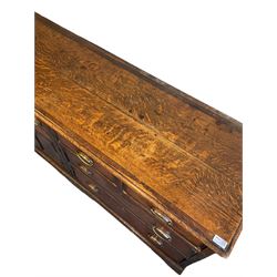 George III oak dresser, rectangular tope crossbanded with mahogany, fitted with five drawers and two cupboard doors, raised on bracket feet
