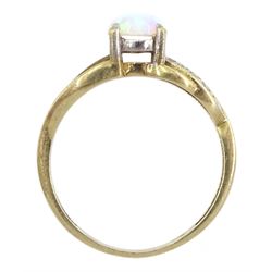Gold opal ring with cubic zirconia shoulders, stamped 9K