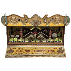 20th century miniature electric musical 'Calliope' fairground wagon, modelled as a wooden domed railway box car in maroon paint inscribed 'Modern Amusements on Tour', the side hinges to reveal pipes and drums with musician circus figures, the low section inscribed 'Old Time Country Fair, the rear hinges open to reveal the electric operator system, on wooden carriage with rubber wheels and metal A-frame drawbar, brass makers plate to end inscribed 'Built 1974 Trevett Chalbury'