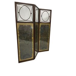 Early to mid-20th century oak framed three fold screen, the glazed panels enclosing peacock feathers with striped fabric to the reverse