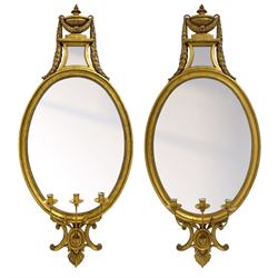 Pair of late 20th century Neoclassical design giltwood girandole wall mirrors, the pediment decorated with urn interlaced with laurel leaf festoon, small waisted mirror plate over oval mirror plate within a moulded frame with beaded slip, three branch candelabra supported by C-scrolled lower bracket decorated with leaf

Designed for the late Dowager Lady St Oswald by Francis Johnson (Yorkshire 1911-1995) circa. 1990s and made by Dick Reid (Newcastle upon Tyne 1934-2021). 

Together with various proposed designs and working drawings by Johnson. 

Provenance: From the Estate of the late Dowager Lady St Oswald