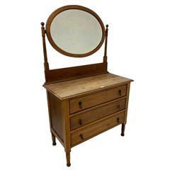 Edwardian walnut dressing chest, fitted with oval swing mirror with bevelled plate, rectangular top over panelled sides, fitted wit three drawers