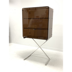 Mid 20th century two door cabinet, the top section from line bent brown frosted lucite with two shelves, raised on a chrome 'X' frame support, W75m, H149cm, D40cm