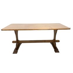 20th century oak refectory style dining table, the rectangular top with moulded edge raised on shaped panel end supports carved with Yorkshire rose, united by pegged stretcher and raised on shaped sledge supports 183cm x 100cm, H75cm