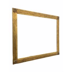 Large rectangular wall mirror, the fluted gilt frame with bulls eye to each corner enclosing bevelled plate 110cm x 141cm