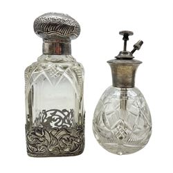 Edwardian silver and cut glass scent bottle with embossed cover and Art Nouveau style pierced silver base by William Hutton & Sons, Birmingham 1907 together with a Sterling silver mounted glass atomizer (2)